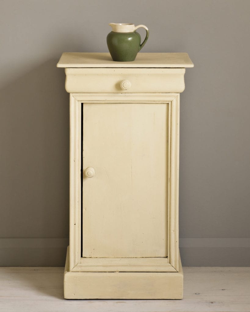 Side table painted with Chalk Paint® in Cream, a soft creamy yellow against a wall of French Linen