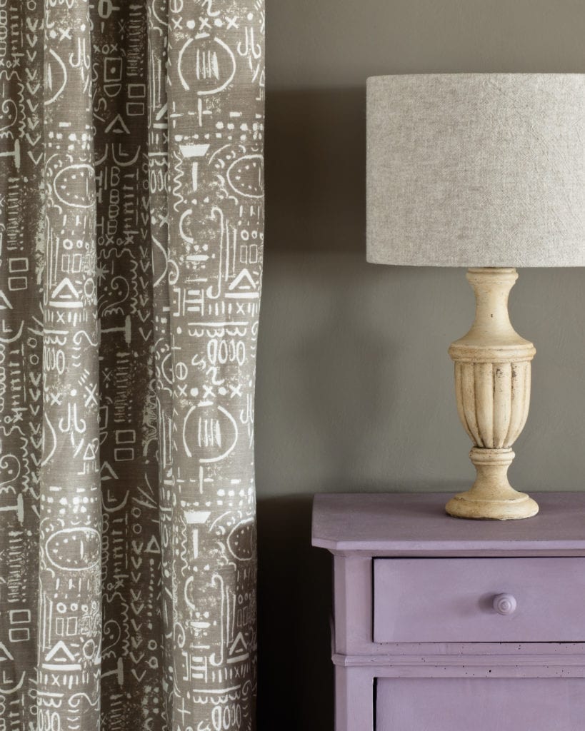Side table painted with Chalk Paint® in Emile, a warm soft aubergine purple against a wall of French Linen. Tacit in French Linen curtain and Linen Union in Old White + French Linen lampshade