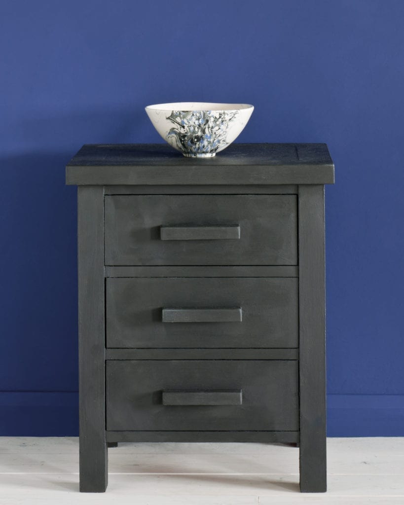 Side table painted with Chalk Paint® in Graphite, a soft charcoal grey black against a wall of Napoleonic Blue