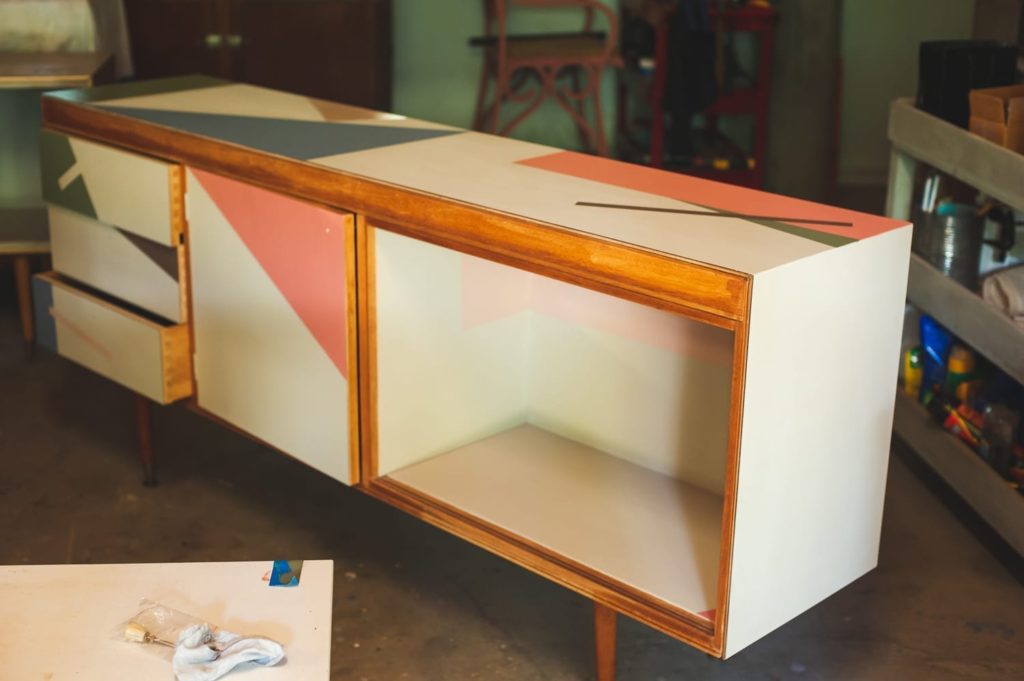 Mid-century modern sideboard painted with Chalk Paint® by Annie Sloan Painter in Residence Polly Coulson with geometric shapes - during