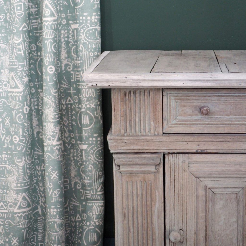 Washed oak cupboard with Chalk Paint® by Annie Sloan in Duck Egg Blue. Tacit in Duck Egg Blue curtain and Wall Paint in Amsterdam Green