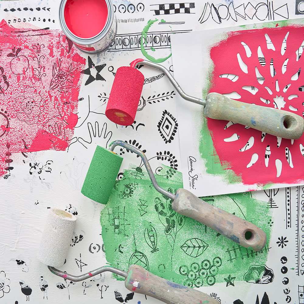 Annie Sloan used Sponge Rollers and a Mixmat to prep Chalk Paint® in Capri Pink, Antibes Green and Pure before using the Floral Stencil to create a patterned design