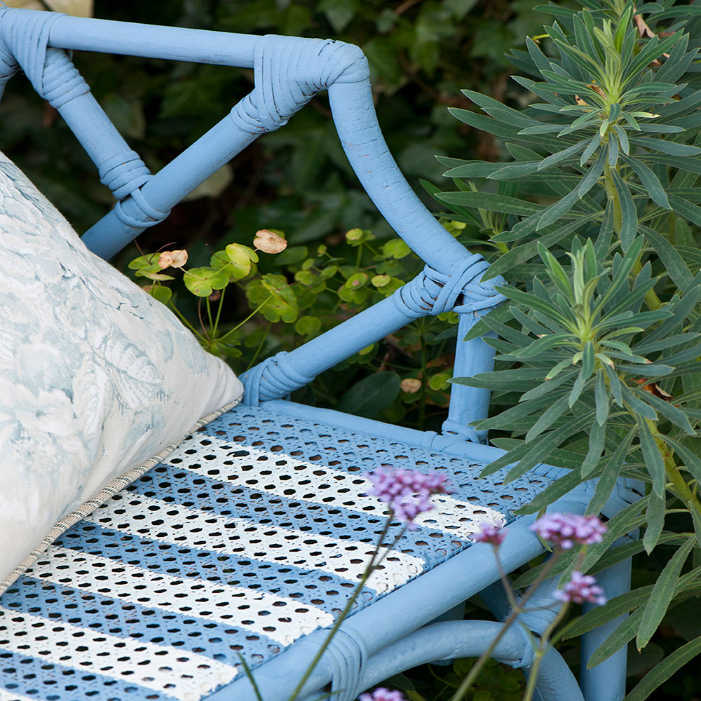 Close up of the Greek Blue and Old White Chalk Paint® stripe details on the seat.