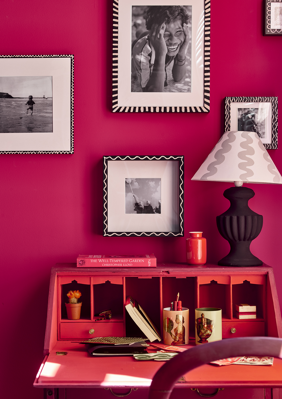 Capri Pink wall paint by Annie Sloan used in an office room, close up of a desk