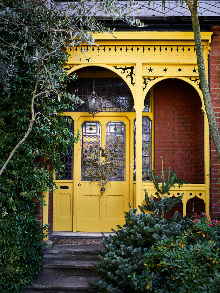 English Yellow Chalk Painted Front Door and Green Foliage