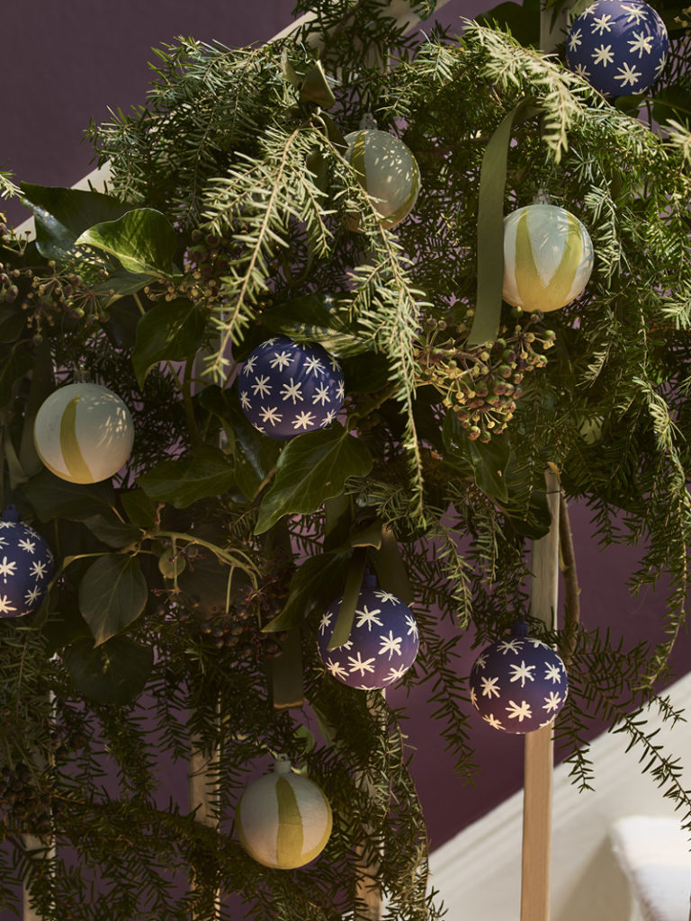 DIY Chalk Paint® Christmas Baubles in Purple and Yellow Stars and Stripes Attached to Staircase Wreath