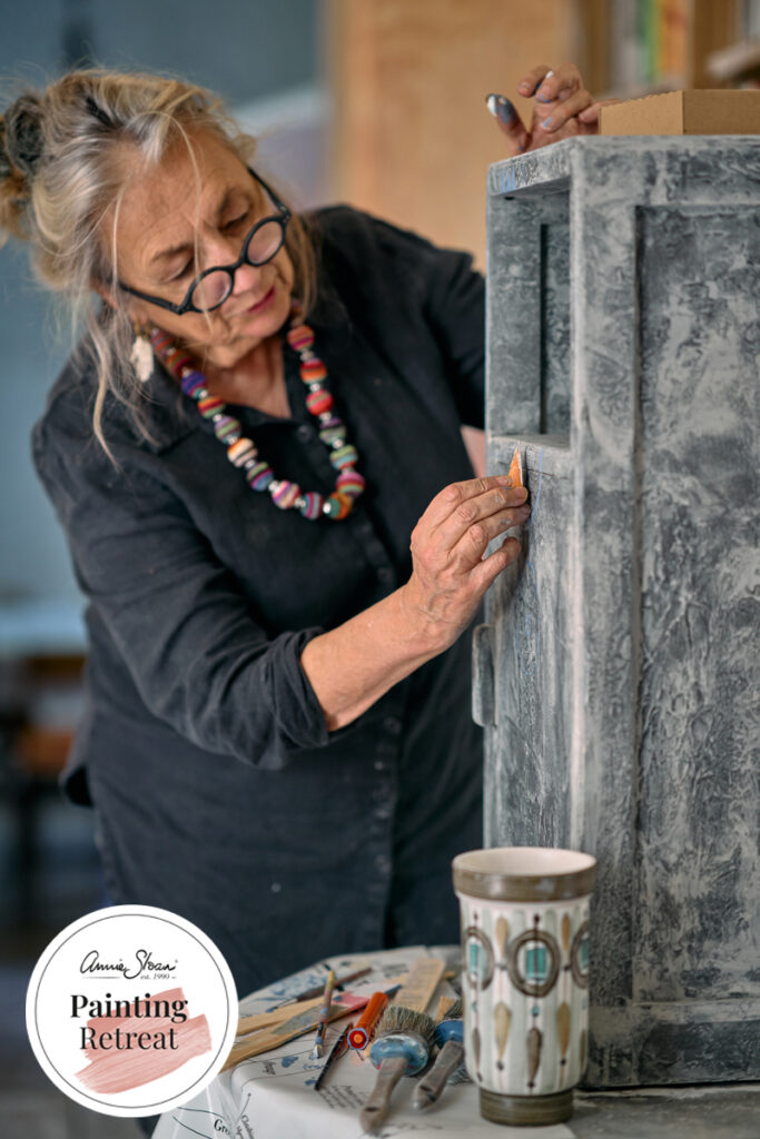 Annie Sloan painting a piece of furniture