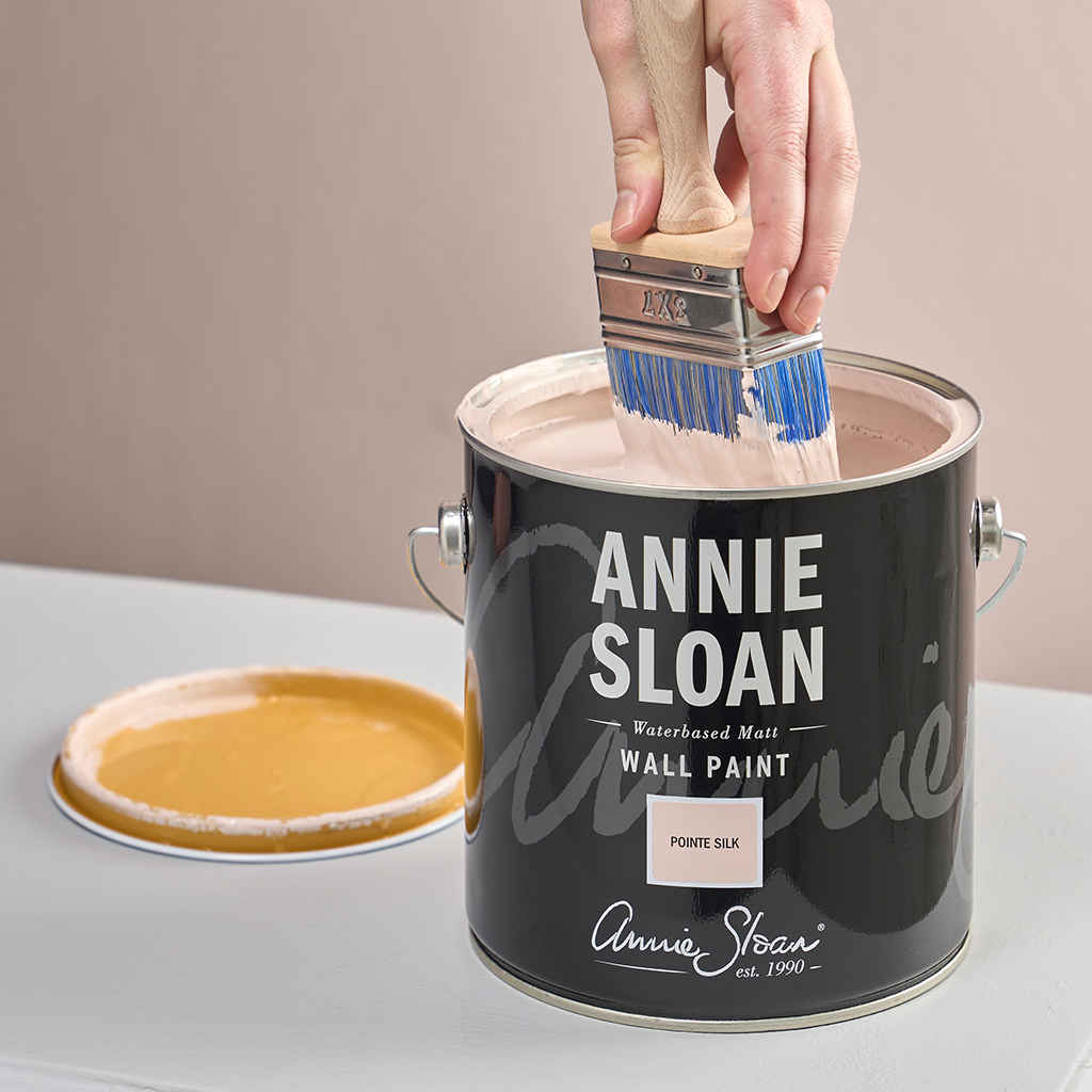 Product Shot of Annie Sloan Wall Paint Brush being dipped in Annie Sloan Wall Paint in Pointe Silk