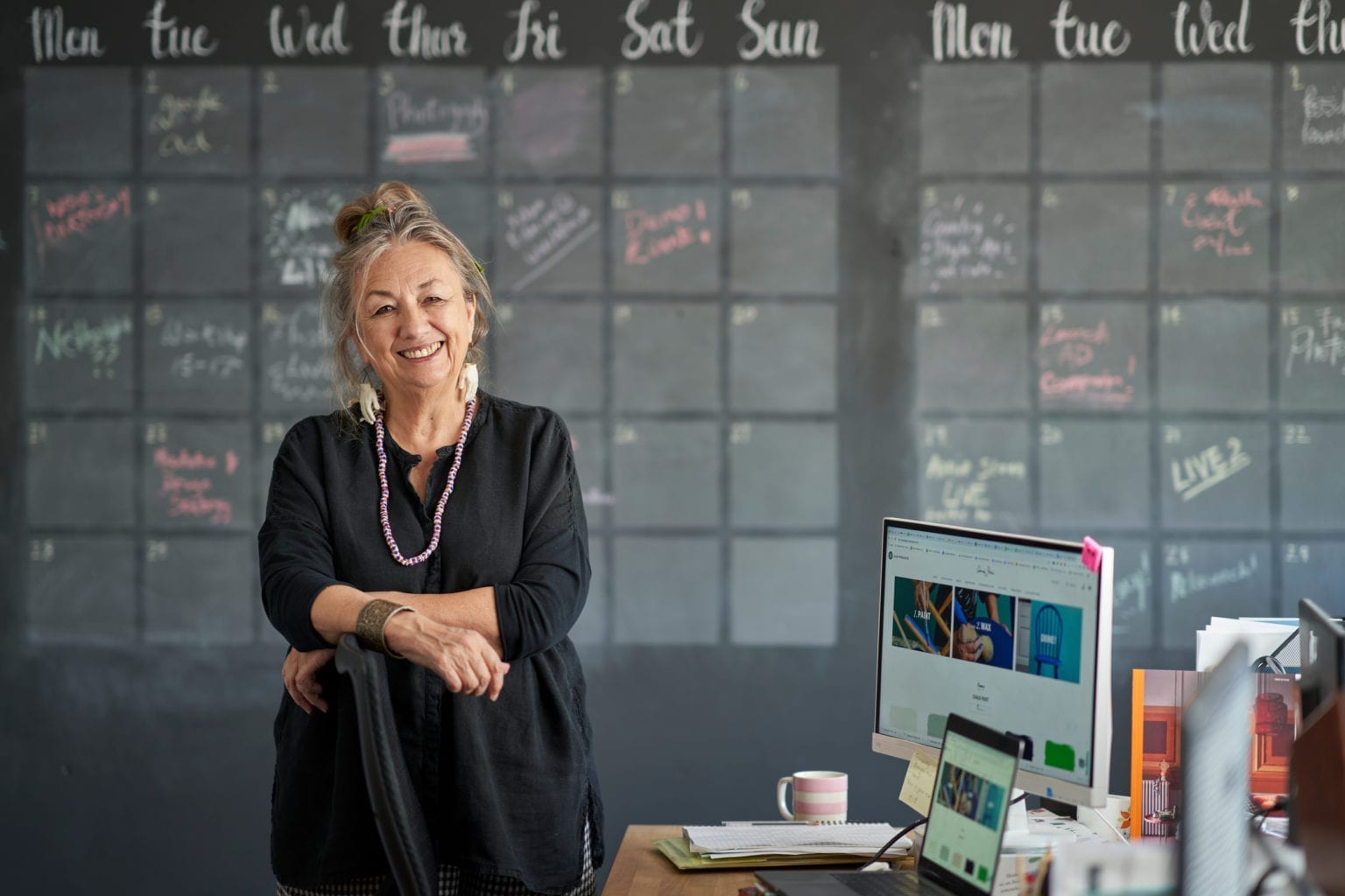 Annie Sloan in her office in Oxford, England. Wall painted with calendar planner