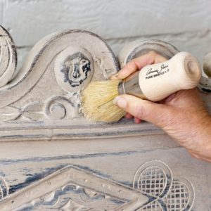 Annie Sloan using Clear Chalk Paint Wax on a rustic bench painted with Old Ochre