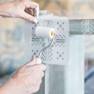 Annie Sloan using a Sponge Roller to apply a Tallulah Stencil with Chalk Paint® in Old White