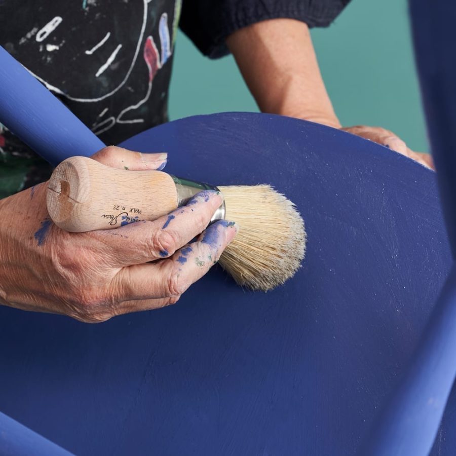 Annie Sloan waxing a dining chair using Clear Chalk Paint® Wax painted in Napoleonic Blue
