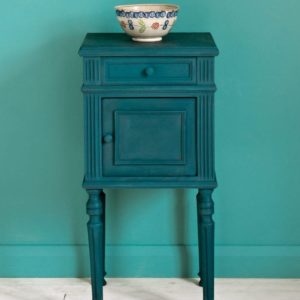 Side table painted with Chalk Paint® in Aubusson Blue, a rich dark classic green-blue teal against a wall of Provence