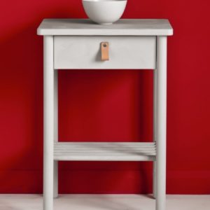 Side table painted with Chalk Paint® in Chicago Grey, a cool, fresh and modern grey, with a hint of blue against a red wall painted with Emperor's Silk