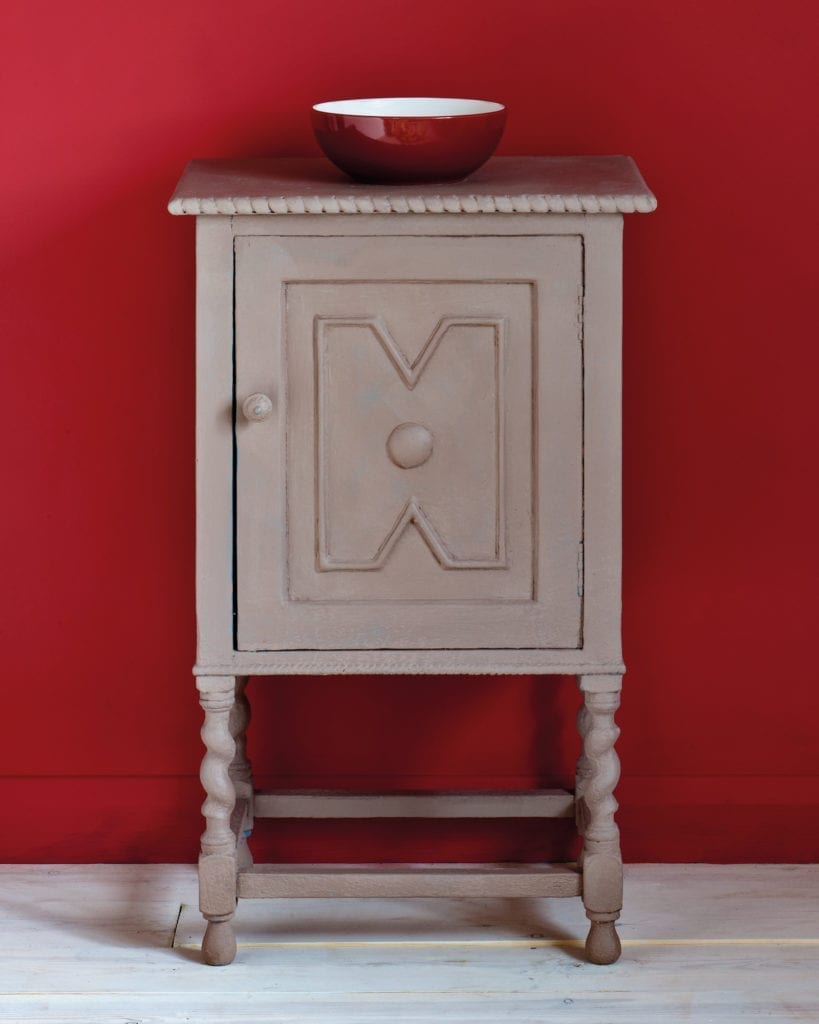 Side table painted with Chalk Paint® in Coco, a soft brown grey against a red wall of Emperor's Silk