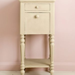 Side table painted with Chalk Paint® in Country Grey, a rustic putty cream beige against a light pink wall of Antoinette
