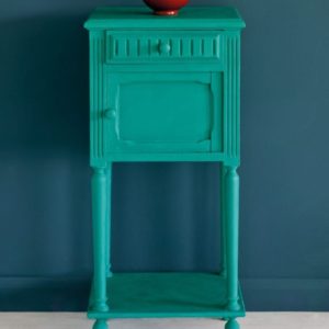 Side table painted with Chalk Paint® in Florence, a bright coppery green colour against a wall of Aubusson Blue