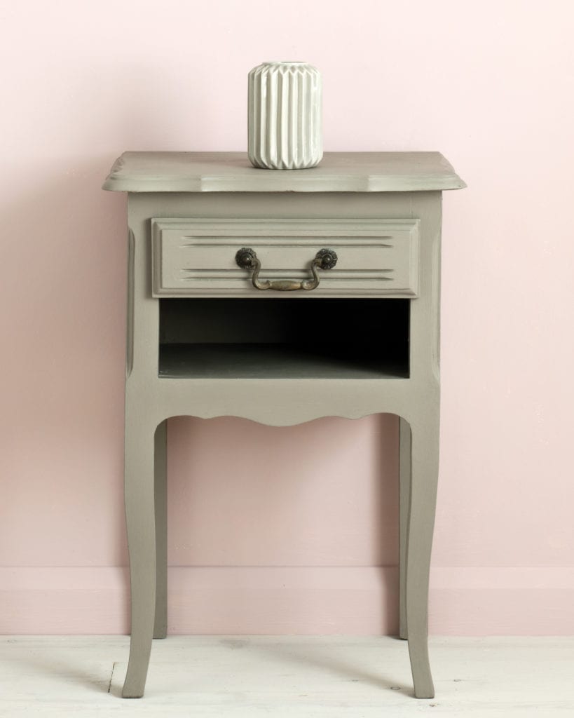 Side table painted with Chalk Paint® in French Linen, cool neutral khaki grey beige against a light pink wall of Antoinette