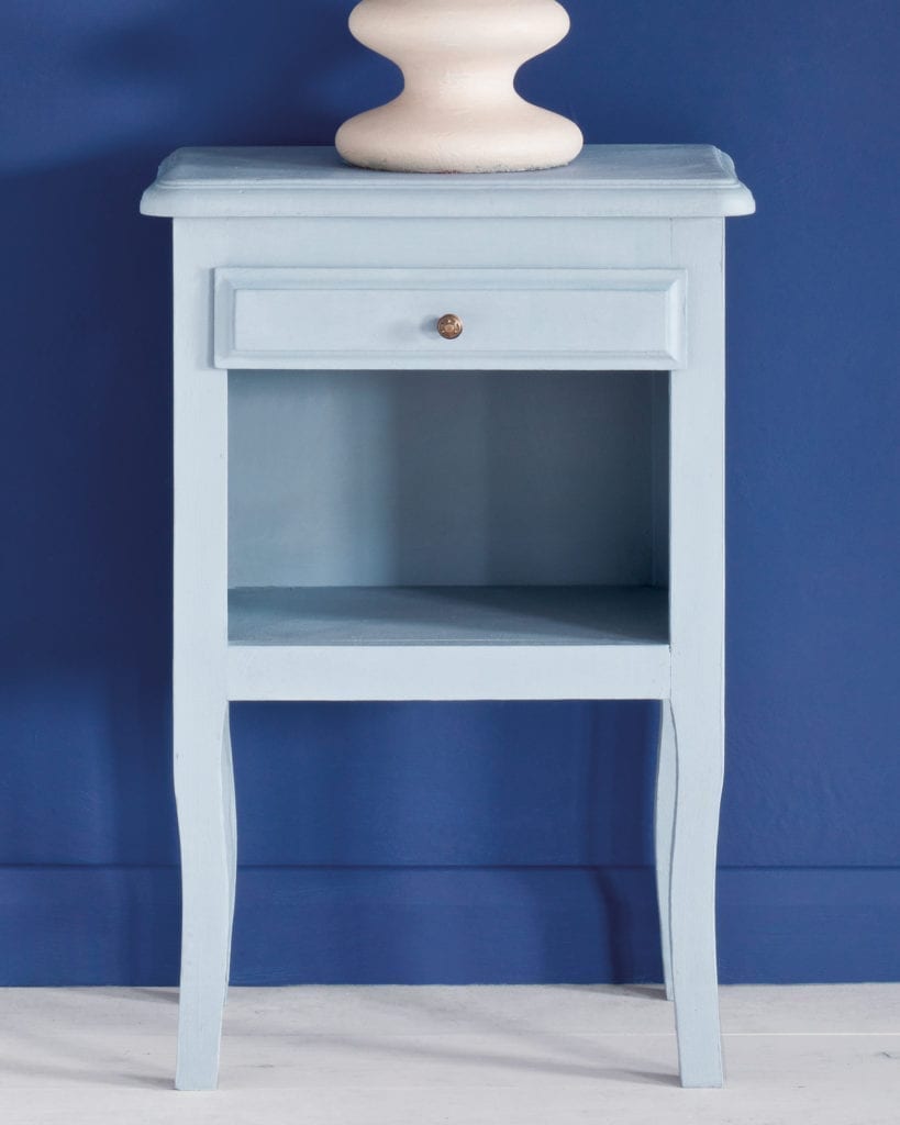 Side table painted with Chalk Paint® in Louis Blue, a clean pastel blue against a wall of Napoleonic Blue