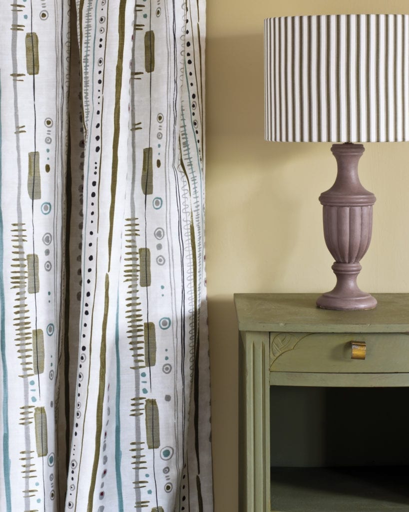 Side table painted with Chalk Paint® in Olive, a traditional olive khaki green. Piano in Olive curtain and Ticking in Olive lampshade