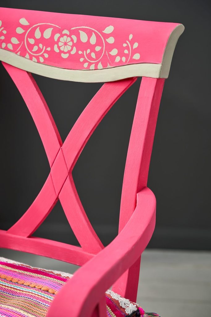 Close up of a chair painted in Capri Pink Chalk Paint® with Faux Bone Inlay template design