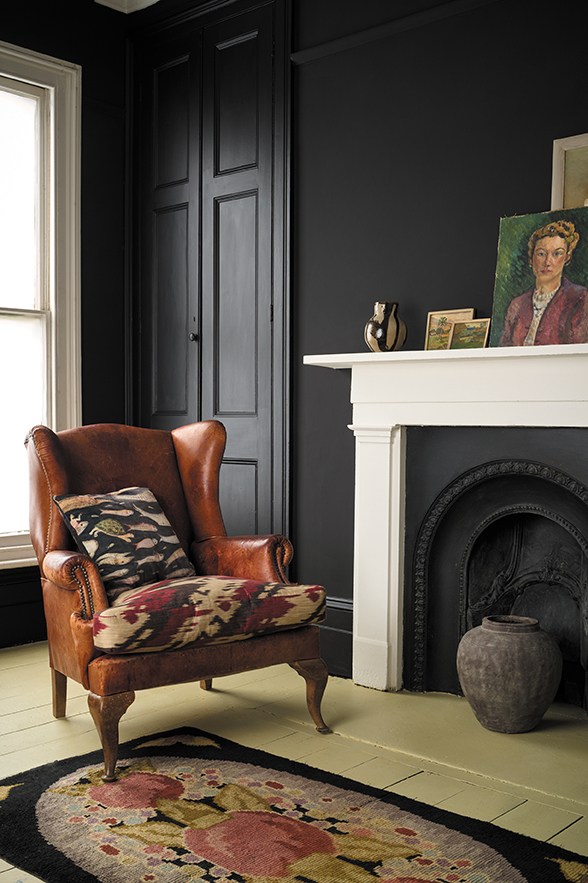 Athenian Black Wall Paint by Annie Sloan behind a tan leather chair