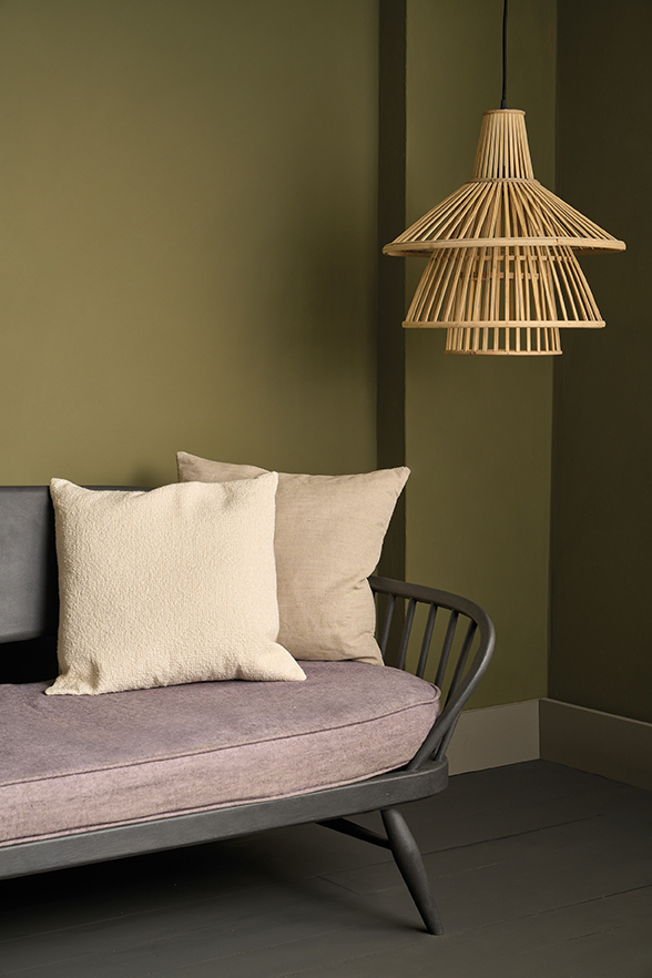 Olive Wall Paint by Annie Sloan used on a wall behind an Ercol sofa