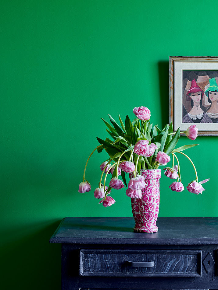 Schinkel Green wall paint by Annie Sloan used on wall behind vase of flowers