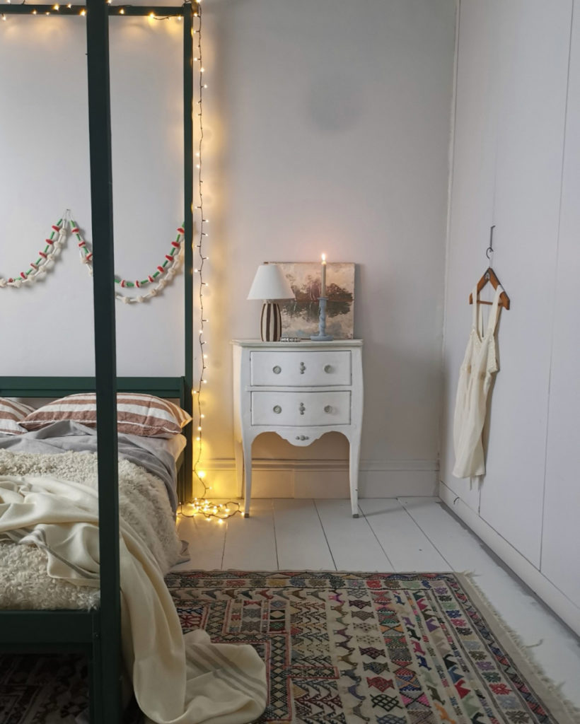 Pompadour wall paint by Annie Sloan used on a bedroom wall behind bedside table
