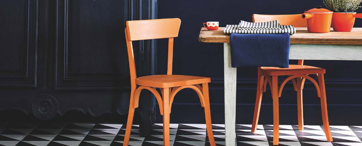Banner image of two chairs painted in orange chalk paint