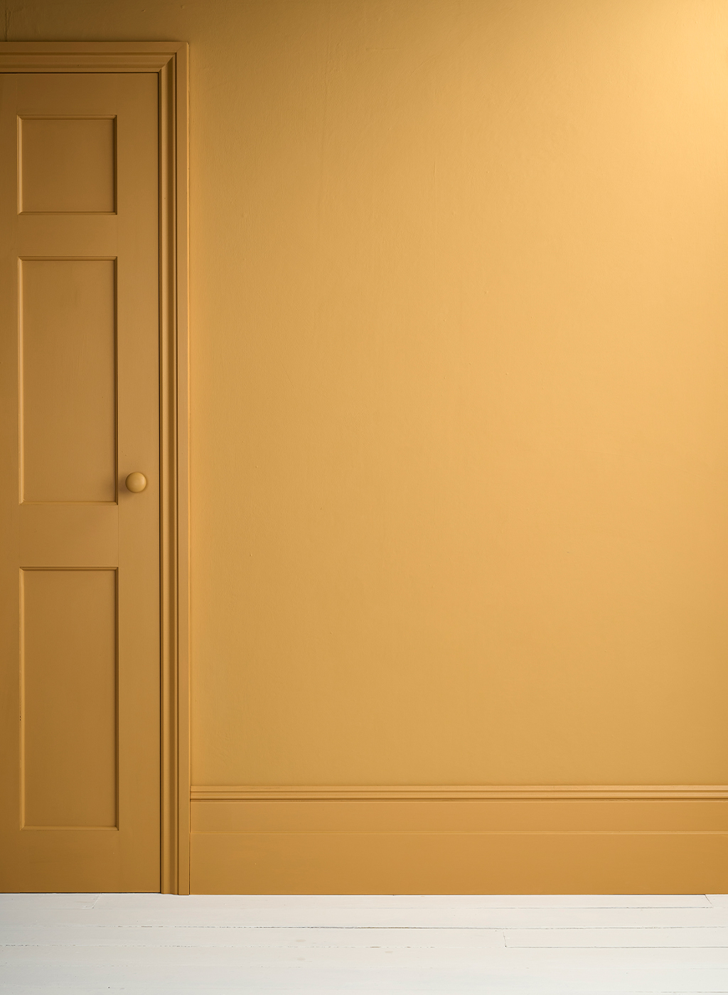 Lifestyle Image of Annie Sloan Satin Paint in Carnaby Yellow used on door and skirting
