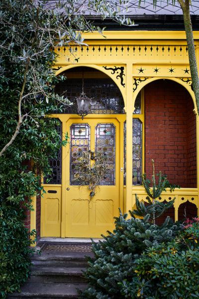 English Yellow Front Door and Green Foliage
