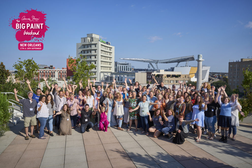 Annie Sloan and a large group of Big Paint attendees on the roof terrace at NOCHI in the sunshine smiling and raising their arms in the air