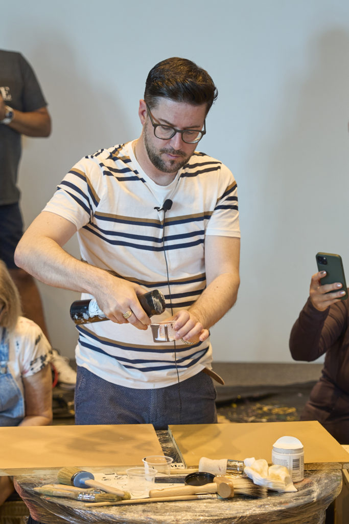 Furniture painter, Jonathan Marc Mendes, giving a demonstration of one of his techniques in NOLA