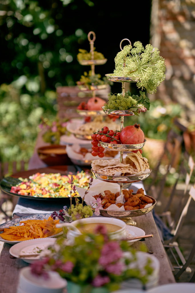 Table full of plates of food and foliage
